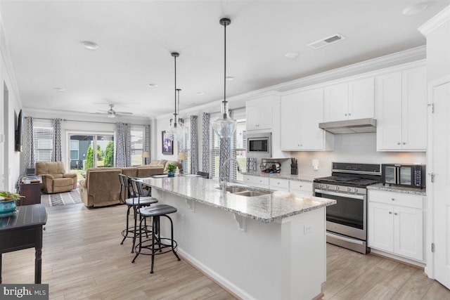 kitchen featuring ceiling fan, sink, decorative light fixtures, white cabinets, and appliances with stainless steel finishes