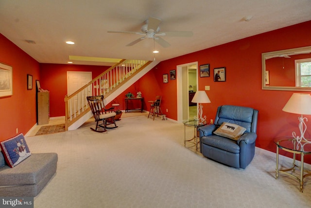 living room featuring carpet flooring and ceiling fan