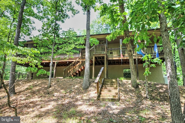 rear view of property featuring a deck