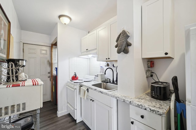 kitchen with light stone countertops, decorative backsplash, dark wood-type flooring, sink, and white cabinetry