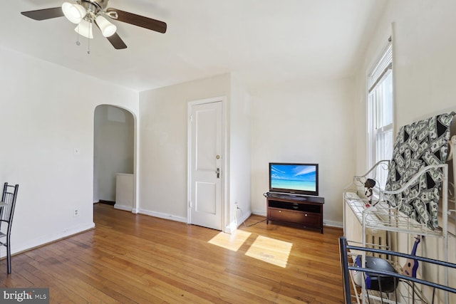 living room featuring hardwood / wood-style flooring and ceiling fan