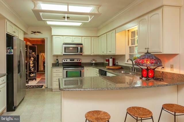 kitchen with stone counters, a breakfast bar, sink, kitchen peninsula, and stainless steel appliances