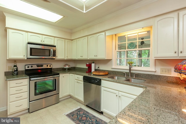 kitchen with sink, ornamental molding, stainless steel appliances, and stone countertops