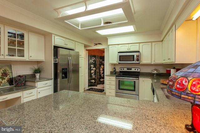 kitchen with ornamental molding and stainless steel appliances