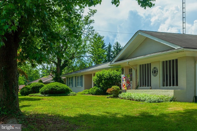 view of side of home featuring a yard