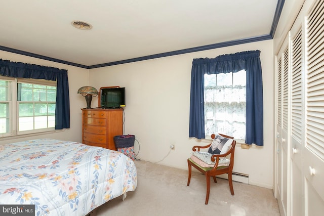 carpeted bedroom featuring crown molding and a closet