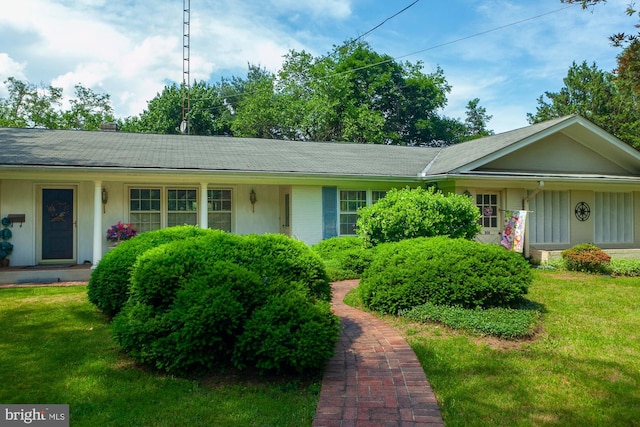 ranch-style home with a front lawn