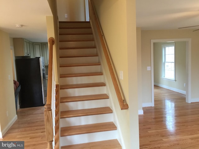 stairs featuring baseboards and wood finished floors