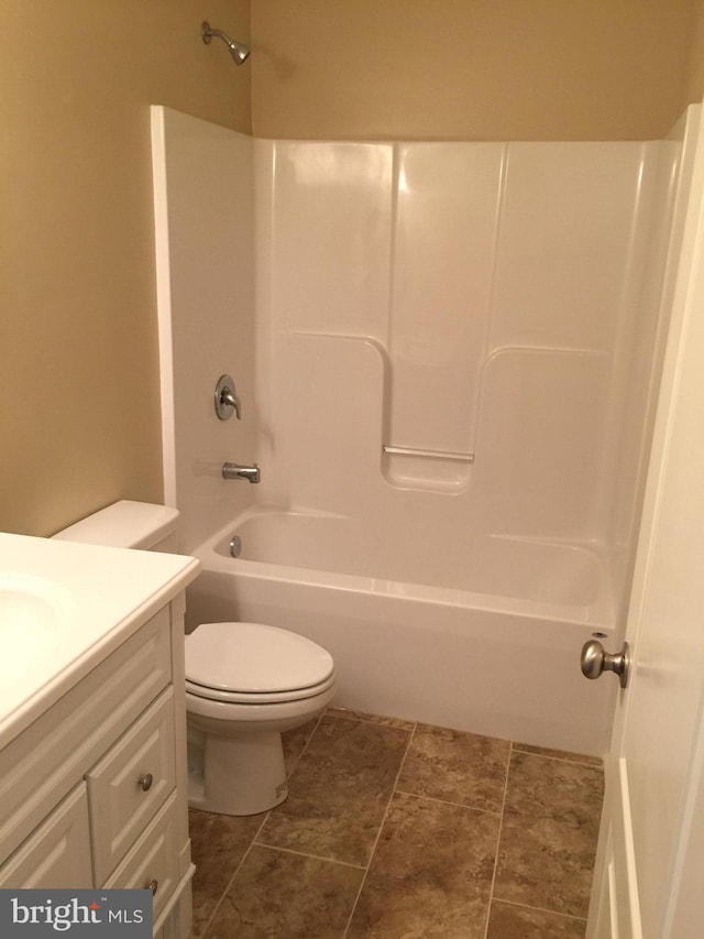 bathroom with toilet, shower / bathtub combination, and vanity