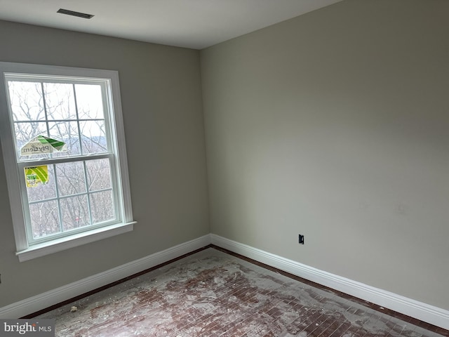 empty room with visible vents and baseboards