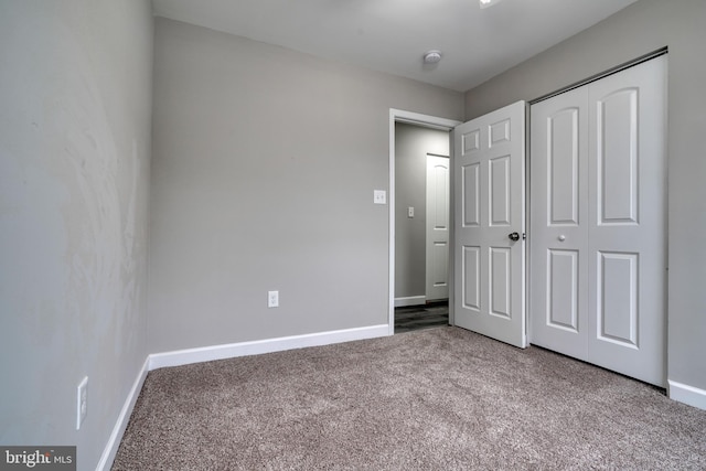 unfurnished bedroom featuring a closet and carpet