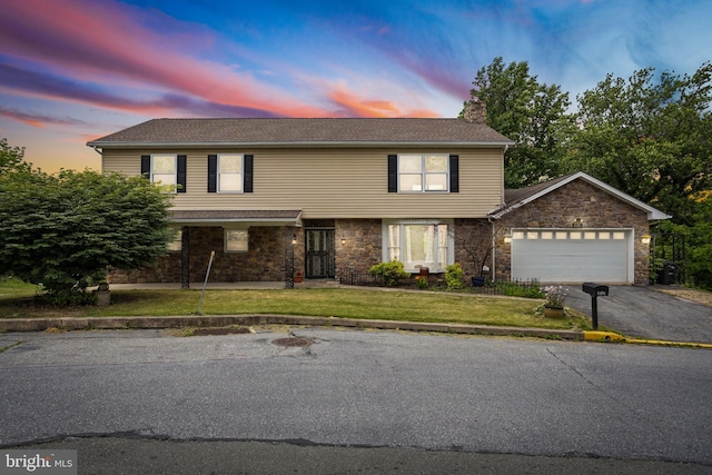 view of front of property with a yard and a garage