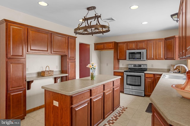 kitchen with a kitchen island, light hardwood / wood-style flooring, hanging light fixtures, a notable chandelier, and stainless steel dishwasher