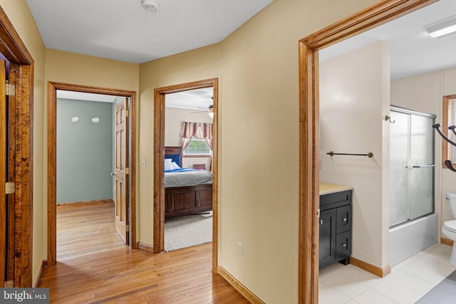 bedroom with ceiling fan, light carpet, and multiple windows