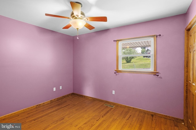 tiled spare room with ceiling fan