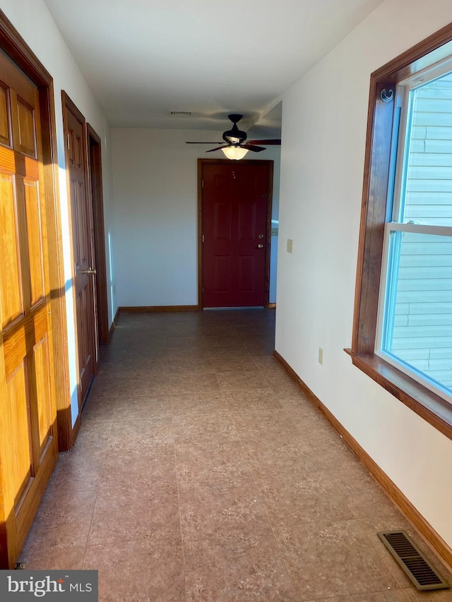 clothes washing area with washer and dryer, light colored carpet, and ceiling fan