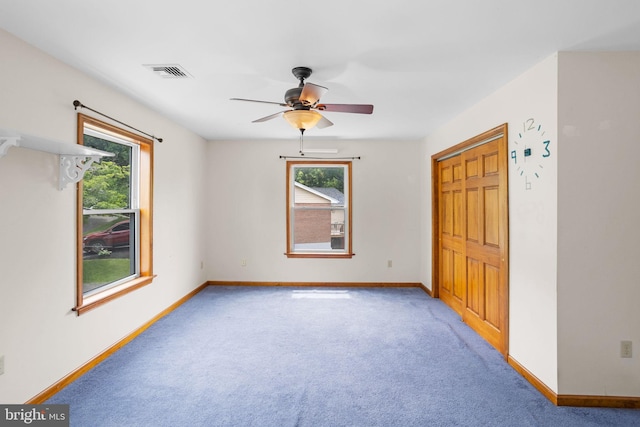 carpeted bedroom with a closet and ceiling fan