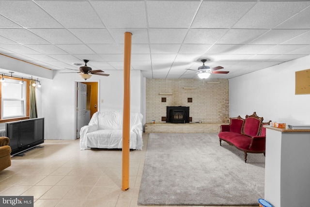 living room with a drop ceiling, a baseboard radiator, and ceiling fan