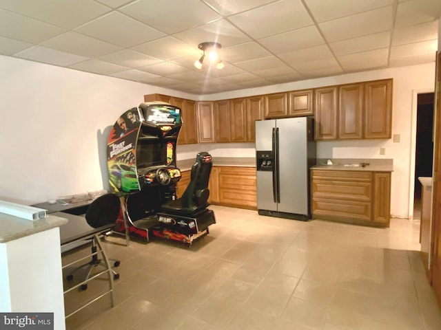 basement with heating unit, electric panel, and a drop ceiling