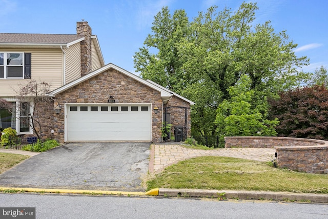 view of front of property featuring a lawn and a garage