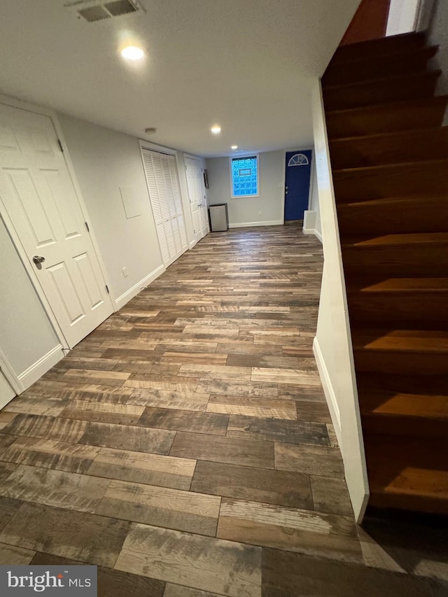 basement featuring dark hardwood / wood-style floors