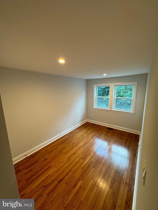 spare room with hardwood / wood-style flooring