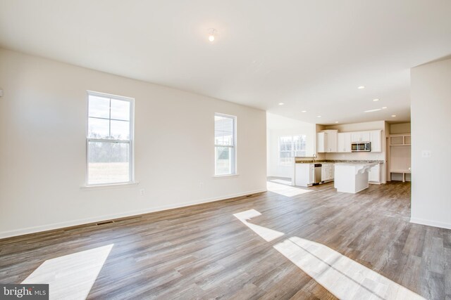 2107 Warrenton Rd, Fredericksburg, VA 22406 - unfurnished living room featuring light wood-style floors, baseboards, and recessed lighting