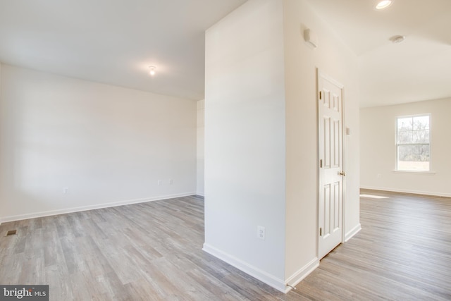 unfurnished room with light wood-type flooring