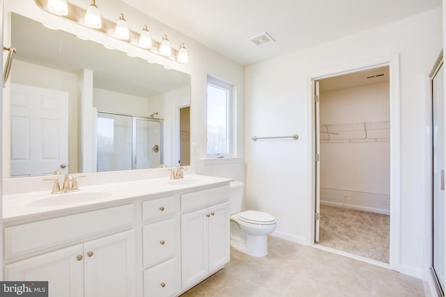 bathroom with vanity, an enclosed shower, and toilet