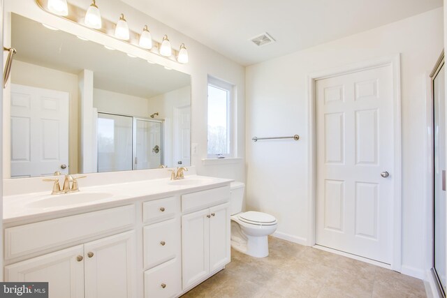 2107 Warrenton Rd, Fredericksburg, VA 22406 - bathroom featuring a stall shower, double vanity, toilet, baseboards, and tile patterned floors