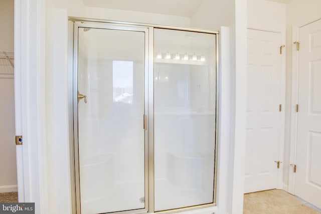 bathroom with tile patterned flooring and an enclosed shower