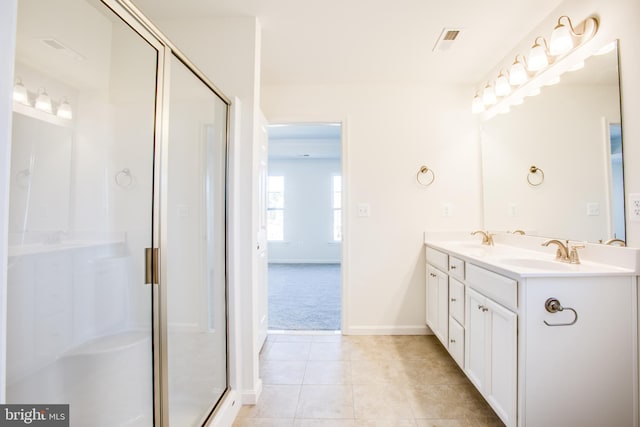 bathroom with tile patterned flooring, vanity, and an enclosed shower