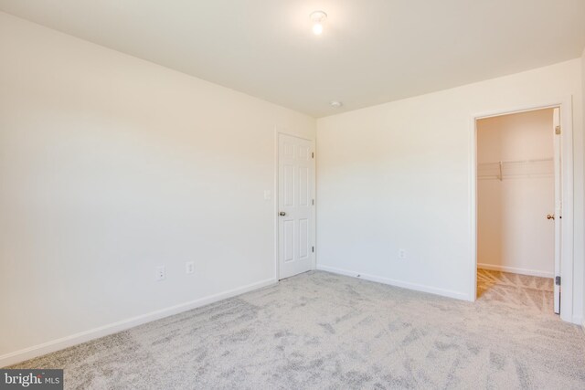 2107 Warrenton Rd, Fredericksburg, VA 22406 - unfurnished bedroom with baseboards, carpet floors, a spacious closet, and a closet