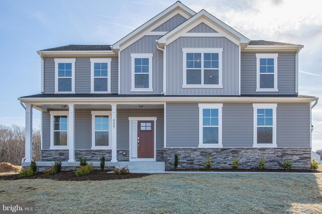 2107 Warrenton Rd, Fredericksburg, VA 22406 - craftsman-style house with a porch, board and batten siding, a front lawn, and stone siding