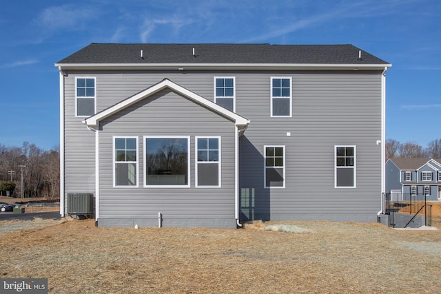 rear view of house featuring central air condition unit