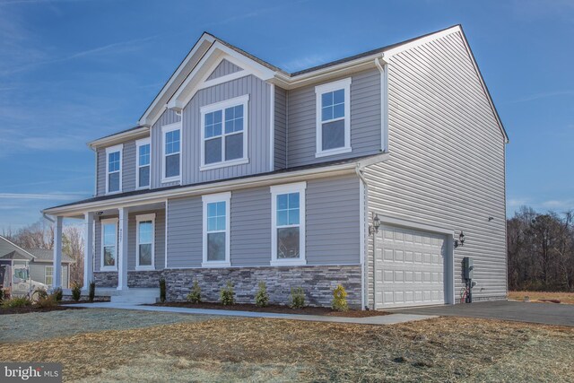2107 Warrenton Rd, Fredericksburg, VA 22406 - view of front facade with asphalt driveway, a garage, stone siding, and a porch