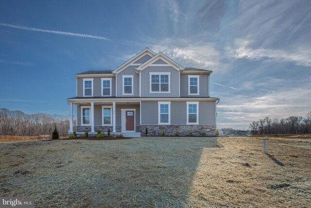2107 Warrenton Rd, Fredericksburg, VA 22406 - view of front of home with stone siding, a porch, board and batten siding, and a front yard