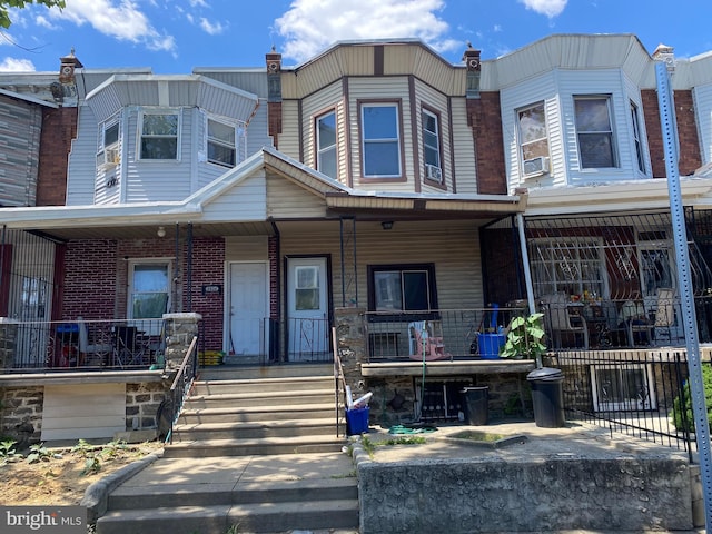 view of property with covered porch and cooling unit