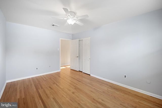 unfurnished room with ceiling fan and light wood-type flooring