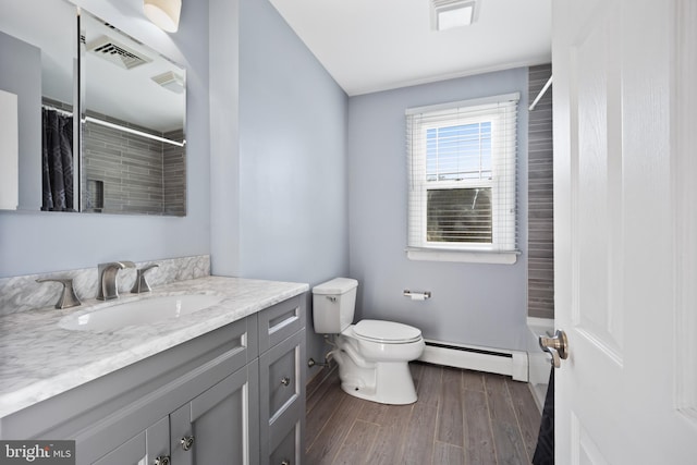 bathroom featuring vanity, a baseboard radiator, toilet, and hardwood / wood-style flooring