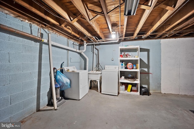 basement featuring washing machine and dryer and sink