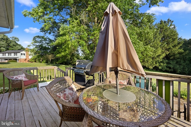 wooden terrace with a grill and a yard