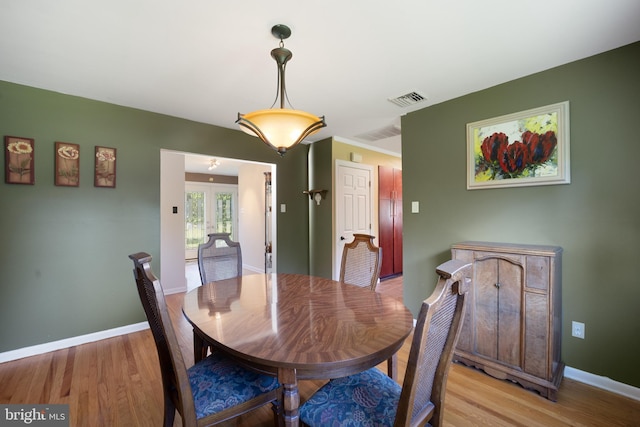 dining area featuring french doors and light hardwood / wood-style floors