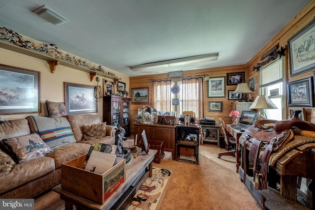 office space featuring plenty of natural light, wood walls, and light colored carpet