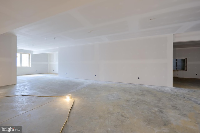 spare room featuring unfinished concrete flooring