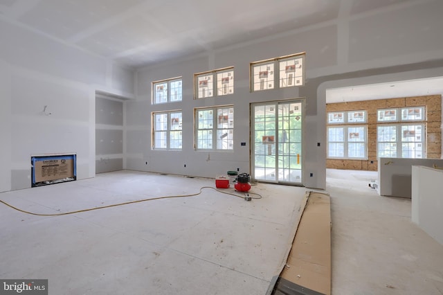 unfurnished living room with a high ceiling