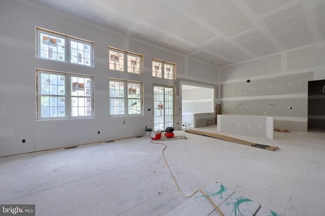 unfurnished living room with a high ceiling