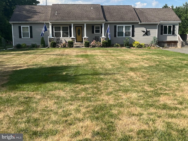 ranch-style home with a front lawn and a porch