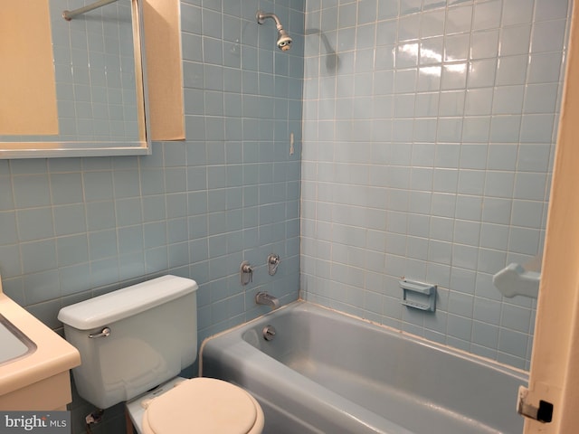 full bathroom featuring vanity, bathtub / shower combination, and toilet