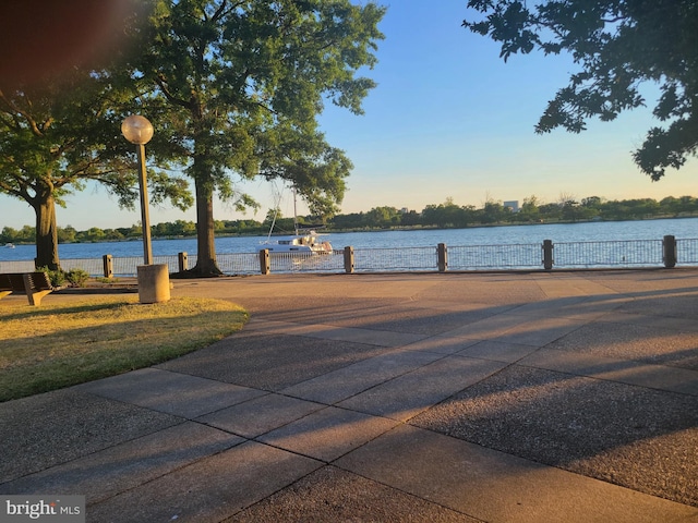 view of property's community featuring a boat dock and a water view